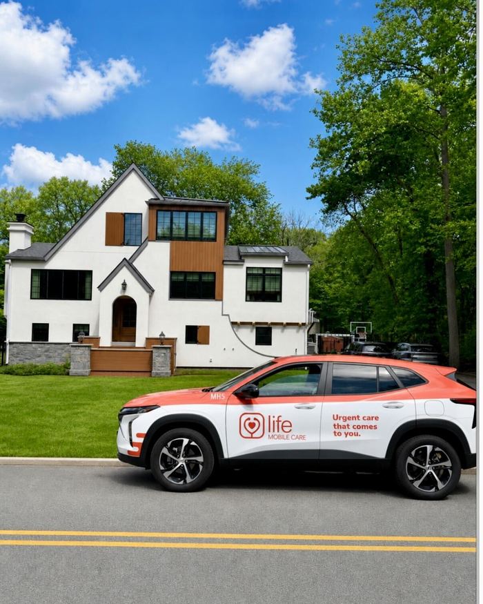 A Life Primary Care vehicle outside a New Jersey home on a clear day