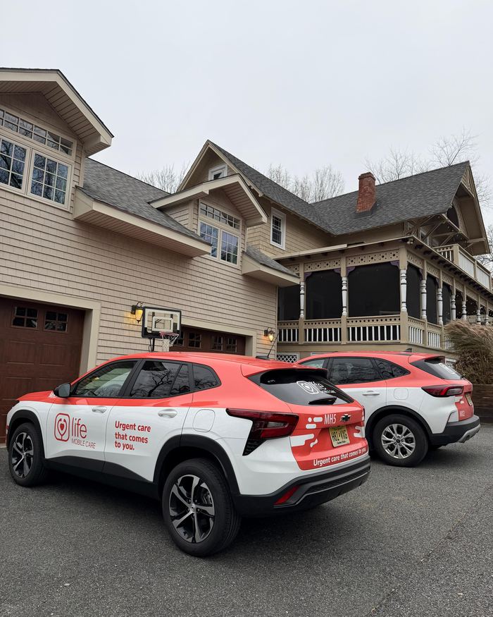 Two Life Primary Care vehicles parked outside a patient's home in New Jersey